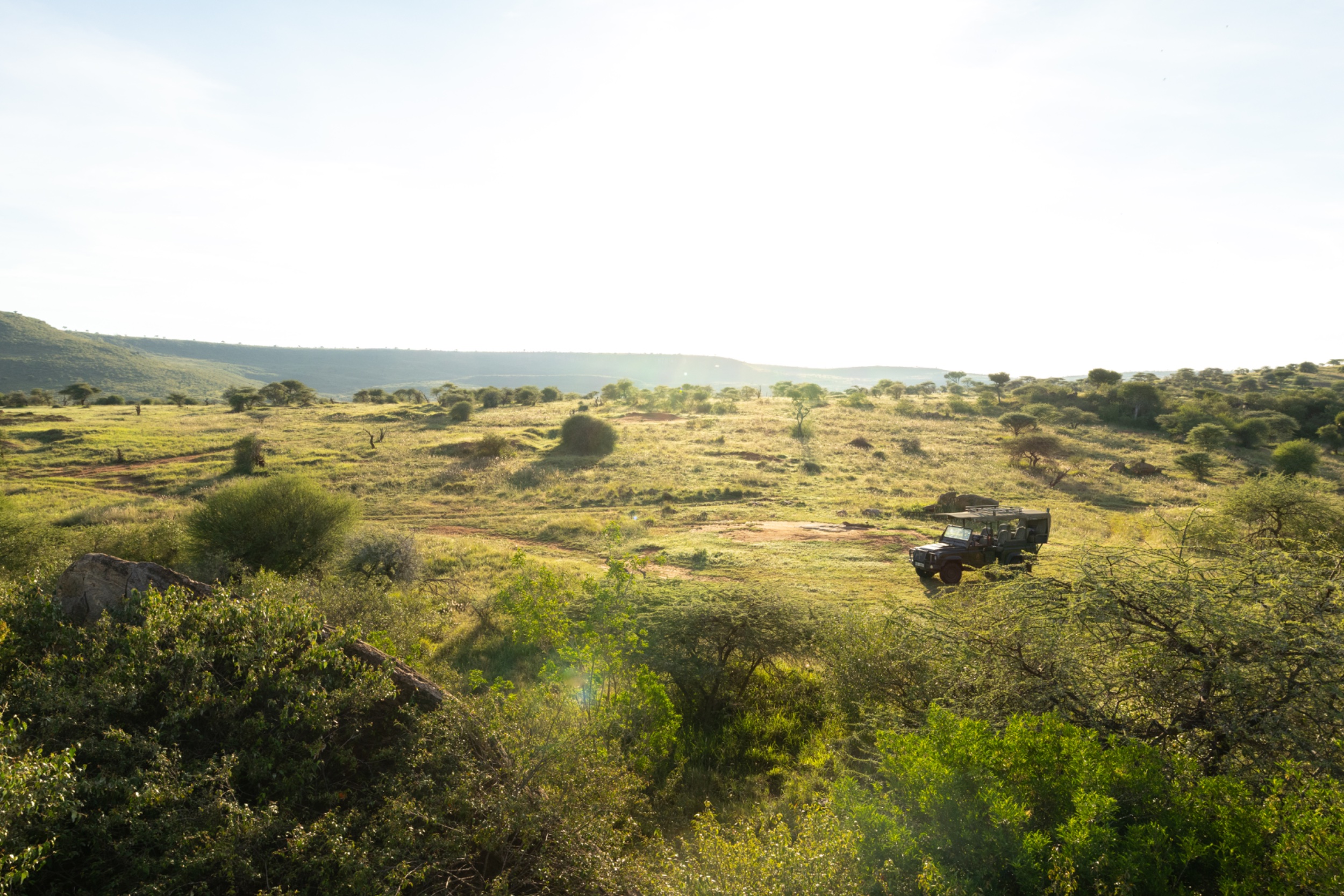 A safari vehicle in the landscape at Elewana Loisaba Tented Camp, Loisaba, Kenya