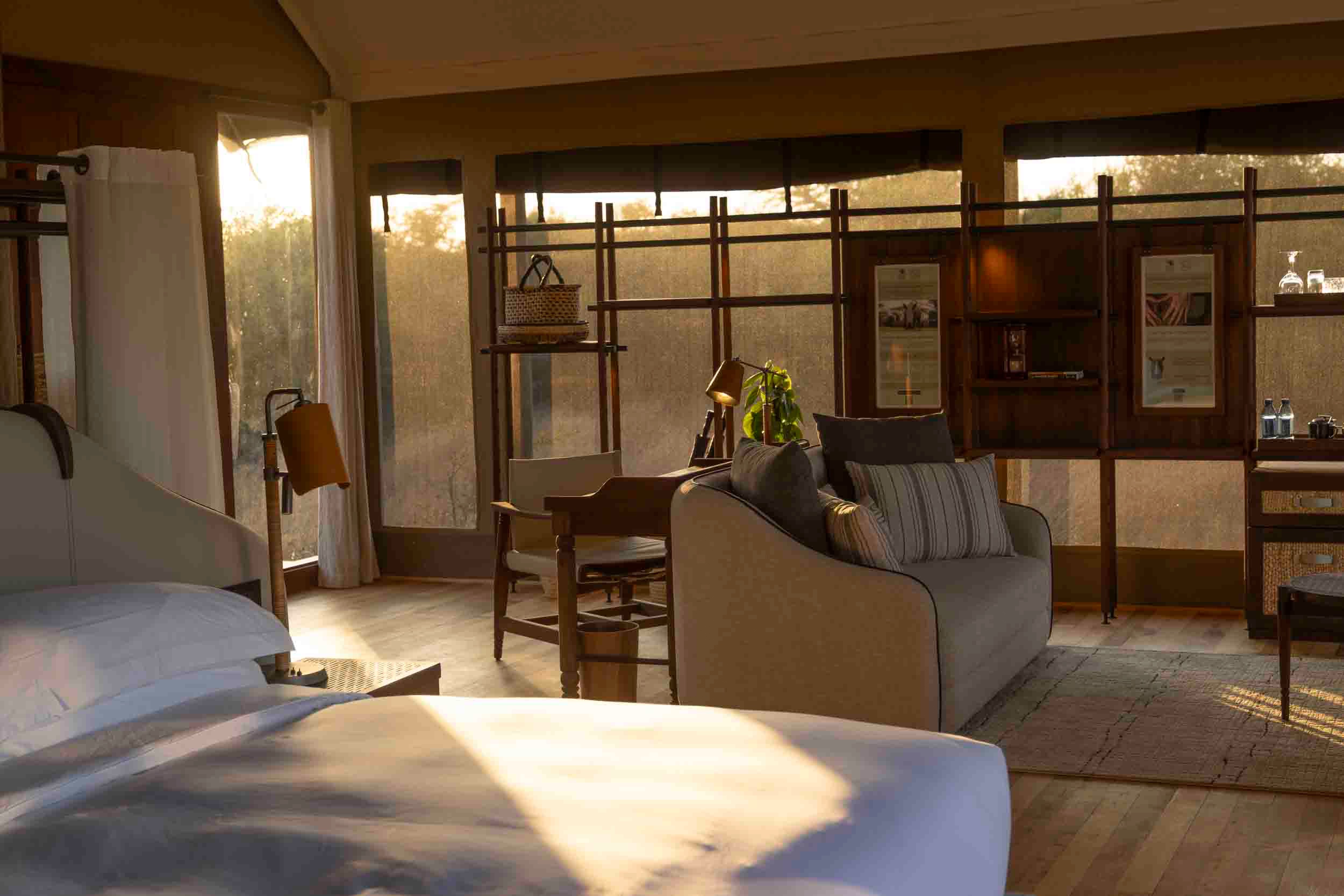 A room at JW Marriott Mount Kenya Rhino Reserve Safari Camp in golden hour light, Kenya